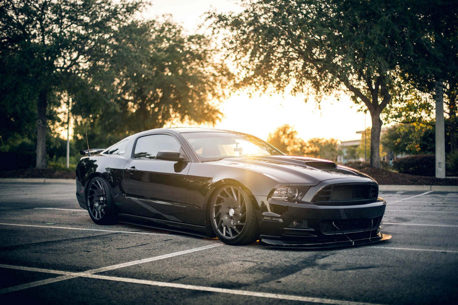 Car parked in a dealership lot at sunset, representing a car dealership working on lead response time