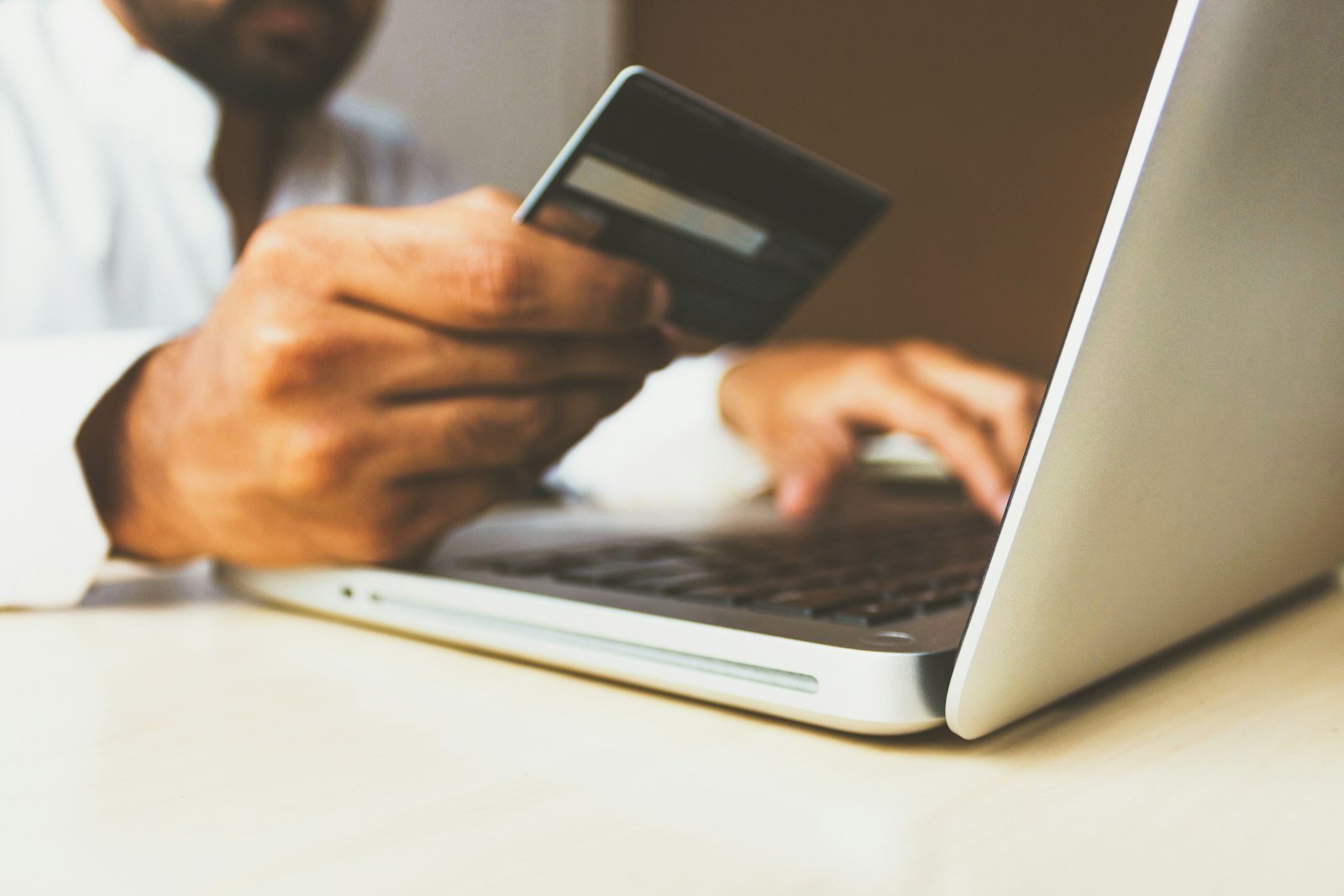 Customer entering card details at checkout on a laptop while shopping online