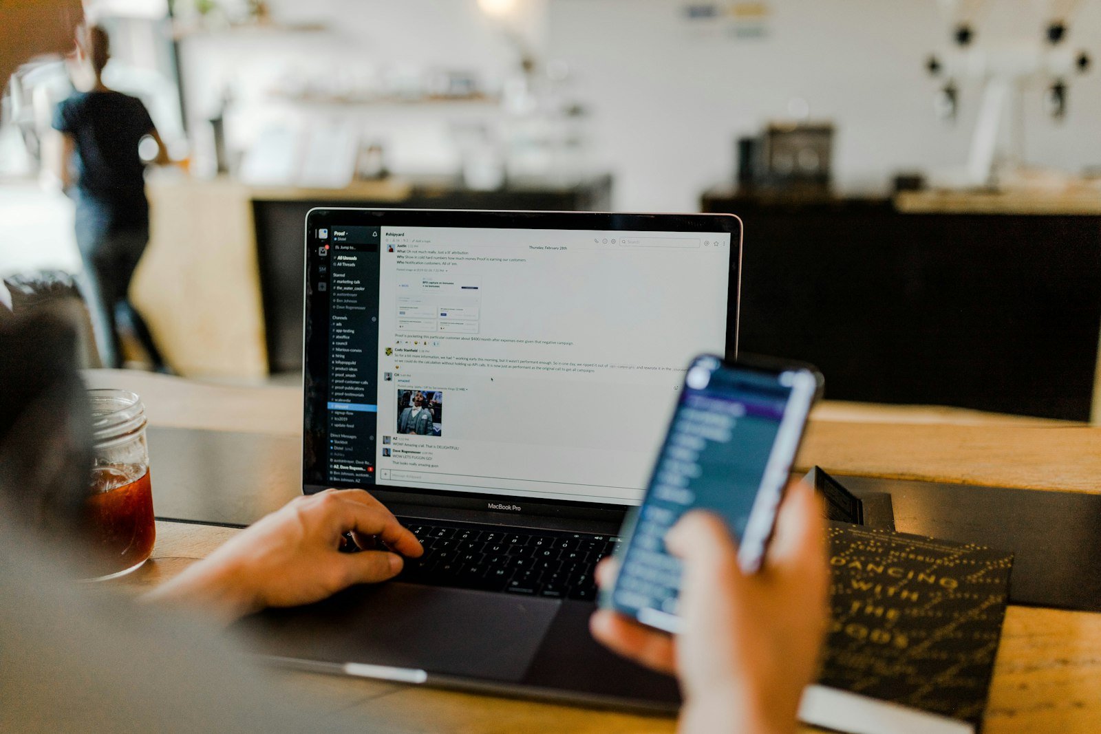Small business owner managing social media on laptop and phone in New Zealand