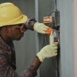 Tradie Website Design Auckland: What Actually Gets You Booked 2 Electrician working on an electrical panel, representing tradie website design in Auckland