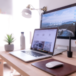 Laptop and notebook on a desk used for planning a website design budget