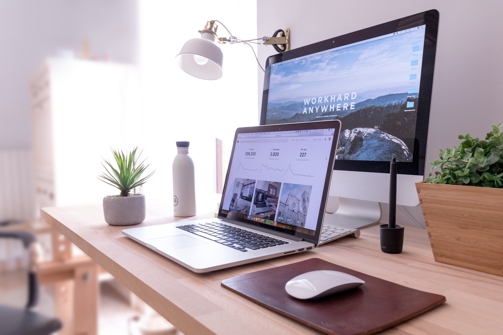 Laptop and notebook on a desk used for planning a website design budget