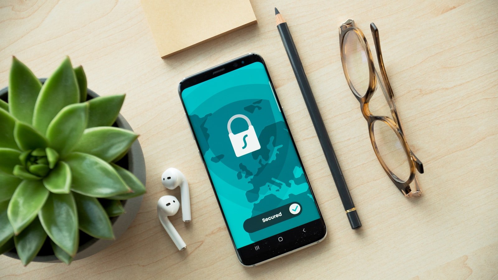 Smartphone showing a Secured padlock screen on a desk, representing website security for small business