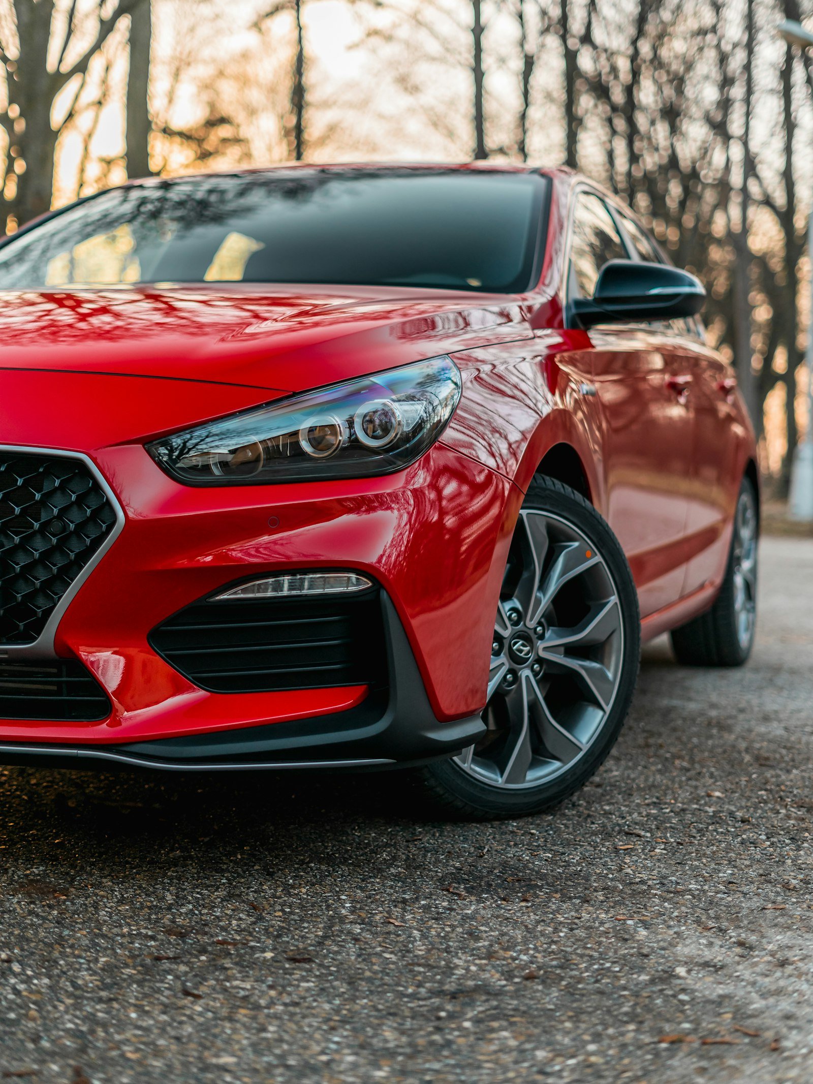Close-up of a red car front end, representing the vehicles NZ buyers research on car dealership websites after hours