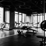 Modern gym floor with treadmills and weight equipment, representing the kind of fitness studio that needs a website built for bookings and trial sign-ups
