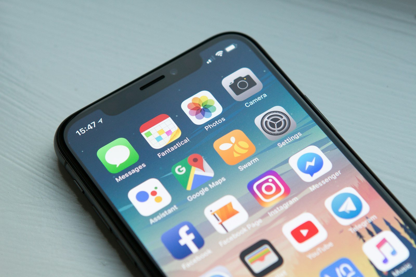 Smartphone home screen showing app icons, illustrating mobile-first website design for small business