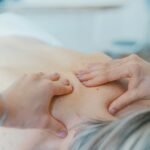 Hands performing manual physiotherapy treatment on a patient, representing physiotherapy clinic website design in Auckland