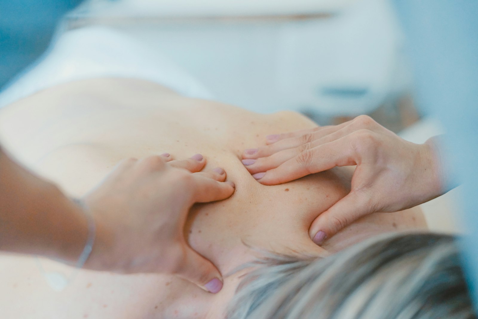 Hands performing manual physiotherapy treatment on a patient, representing physiotherapy clinic website design in Auckland