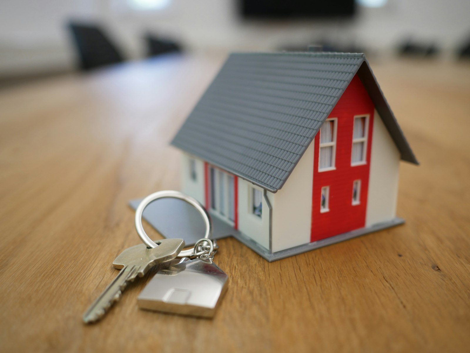 Miniature house model with keys on a table, representing a real estate agent website Auckland buyers and sellers can trust