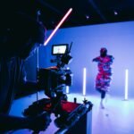 A videographer filming with a cinema camera in a studio, representing YouTube marketing for NZ small business