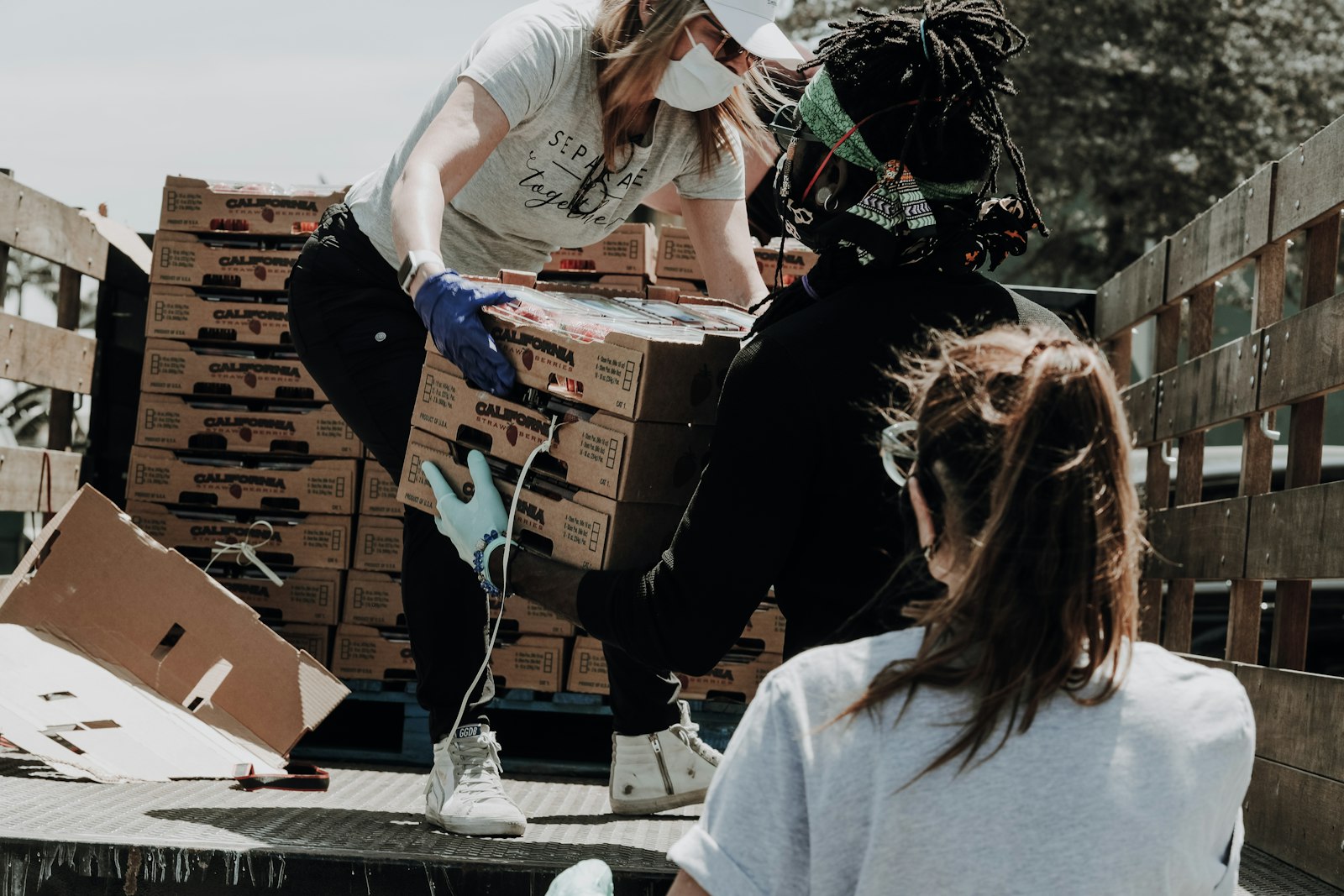 Volunteers loading donated food boxes, representing the trust a charity website needs to earn before someone gives online