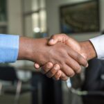 Car Dealership Marketing Attribution NZ: Why Most Sales Go Untracked 1 Business handshake representing a car dealership closing a sale after a fast lead response