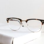 Tortoiseshell eyeglasses resting on a book, representing an Auckland optometry practice website