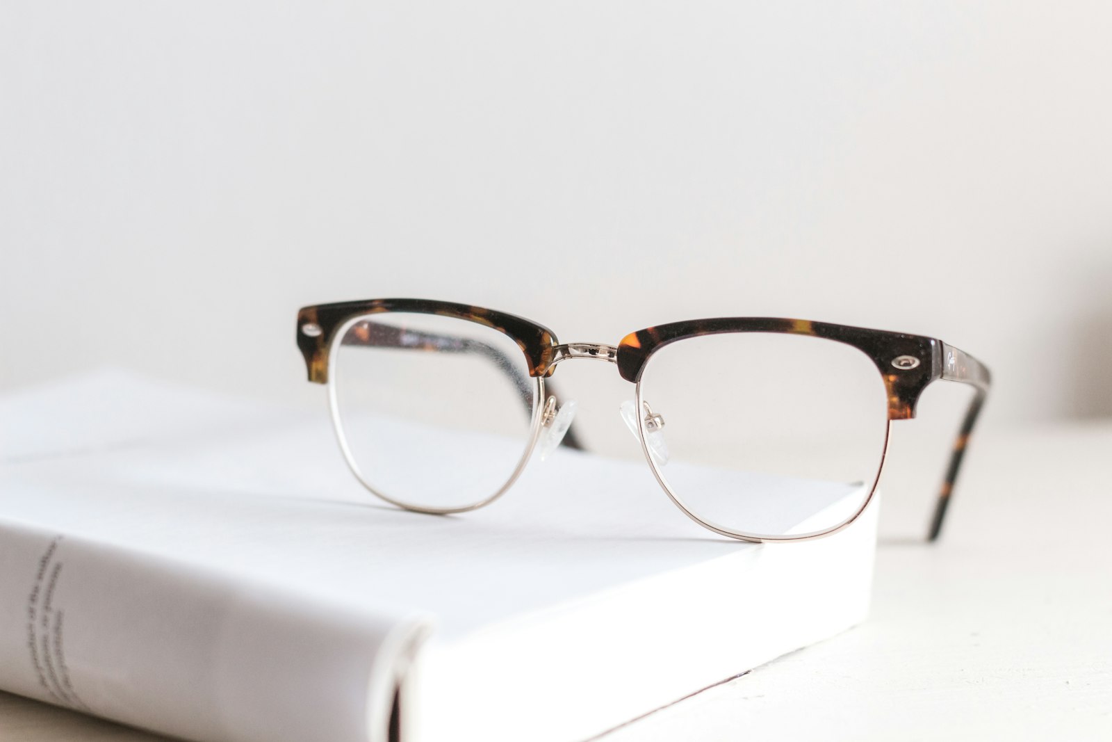 Tortoiseshell eyeglasses resting on a book, representing an Auckland optometry practice website