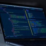 Close-up of code on a laptop screen, illustrating schema markup for small business websites in NZ